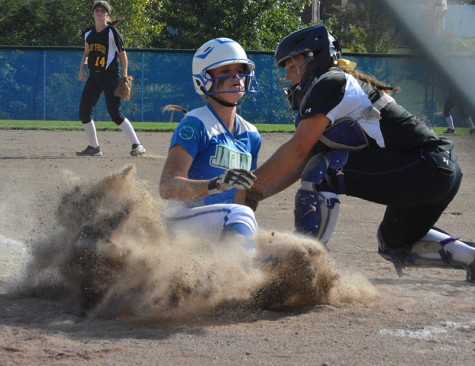 Sophomore Madison Croslin slides into home in a game against Blue Springs. Photo by Laytin Plotter
