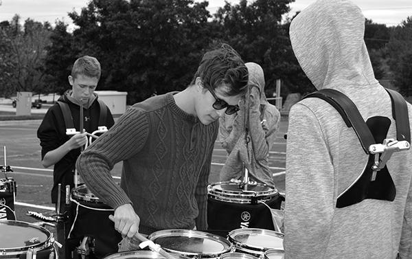 Staff member Bailey Gruben works with senior tenor Kolby Snelling at a percussion sectional. Photo by Delaney Jackson