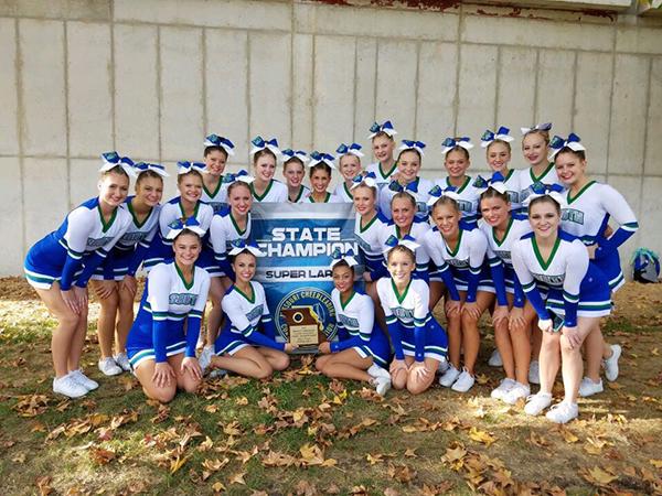 The cheer team poses with their first place trophy. This was the cheer teams first ever first place finish after back-to-back second place finishes. Submitted photo