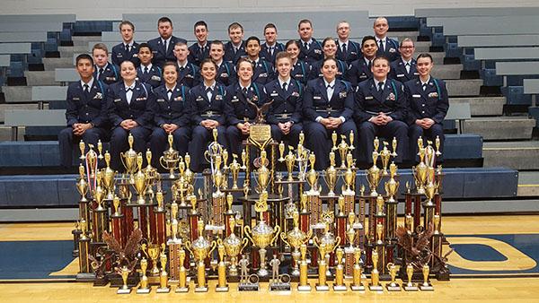 Members of the Blue Springs South Air Force JROTC drill team pose with trophies they have won at competitions this year. They have competed a total of eight meets throughout the school year. Photo submitted.