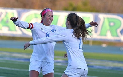 Senior Taylor Gardner and sophomore Brie Severns celebrate after a goal.