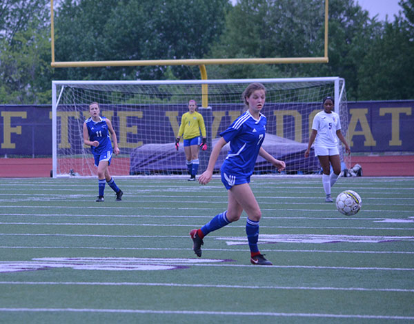 Sophomore Brie Severns chases a ball in a game against Blue Springs on May 8th. Severns was named to the Elite 11, an award honoring talented metro soccer players. Photo by Russell Baker. 