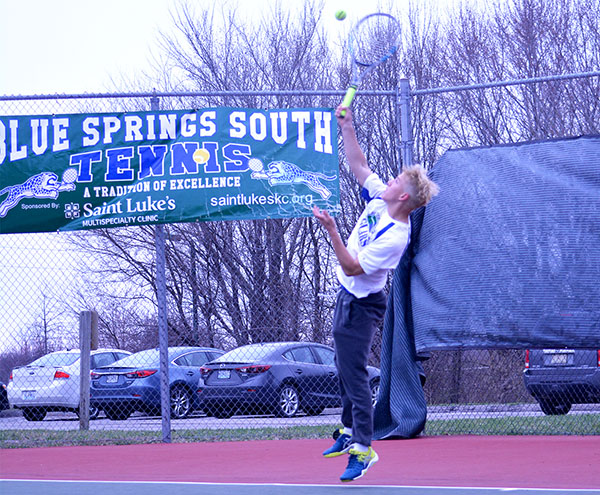 Junior Spencer Jorgenson serves a ball in a recent home match. The Jags beat Lees Summit North and Lees Summit to repeat as district champs. Photo by Francesca Klosener