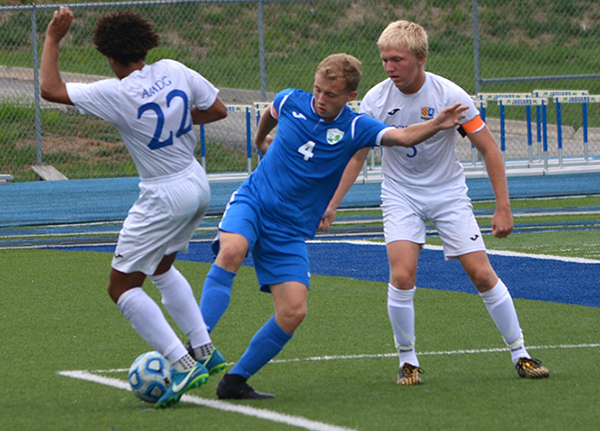 Senior Bryce Millican battles for the ball against Rockhurst.
Millican is the current top scorer on the Blue Springs South team.	Photo by Austin Schofield			 