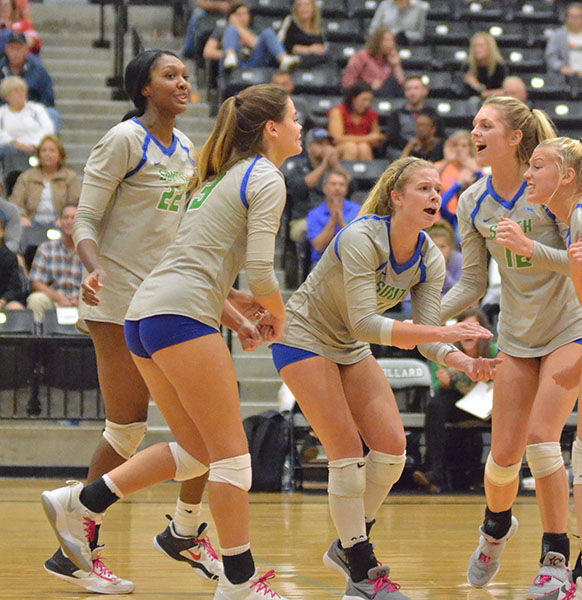 Members of the South volleyball team celebrate a point against Willard. The Jags beat Carl Junction 2-0 to advance to the state quarterfinals, where they lost to Willard, 2-1. Staff photo