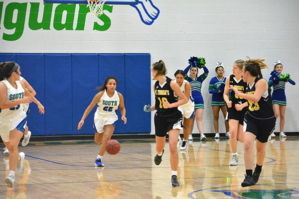 Sophomore Tiyani Rollins dribbling up court against St. Theresas. Photo By: Hailey Schinderling