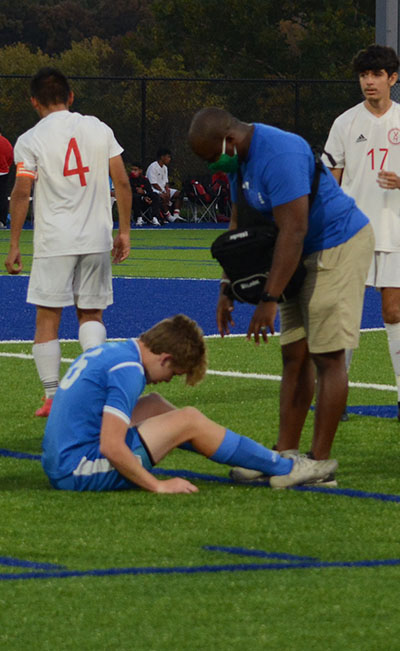 South+trainer+Andre+Taylor+tends+to+a+South+soccer+player+during+a+home+match.+Photo+by+Hailey+Schinderling
