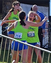 South cross-country athletes Caitlin Grover, left, Maggie Boley and Emmerson Allen celebrate after learning the Jags had  won the state cross-country championship. Photo by Ryan Unruh