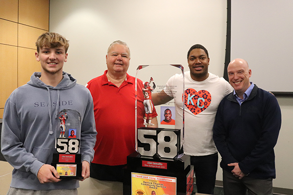Alex Israelite, left, poses with the trophy he received  for the 2022 Derrick Thomas Community Service Award. Also posing with Israelite are Rollie Textor, Derrion Thomas and Bo Czyz. Thomas is the the son of Derrick Thomas and a Blue Springs South graduate. Photo submitted.