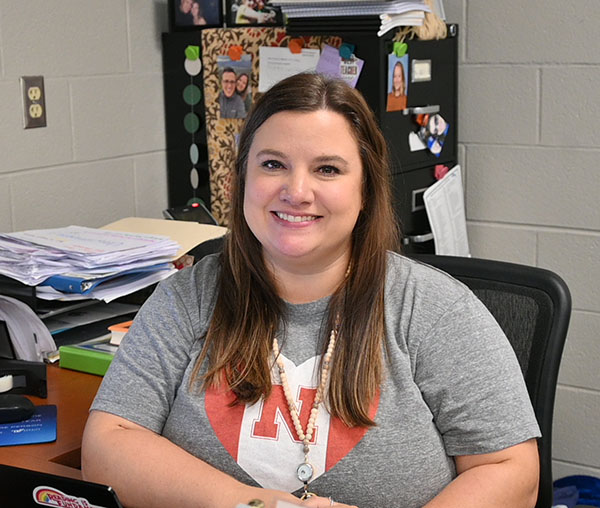Whitney Awalt sits at her desk. When not at school, she enjoys attending live music event. 