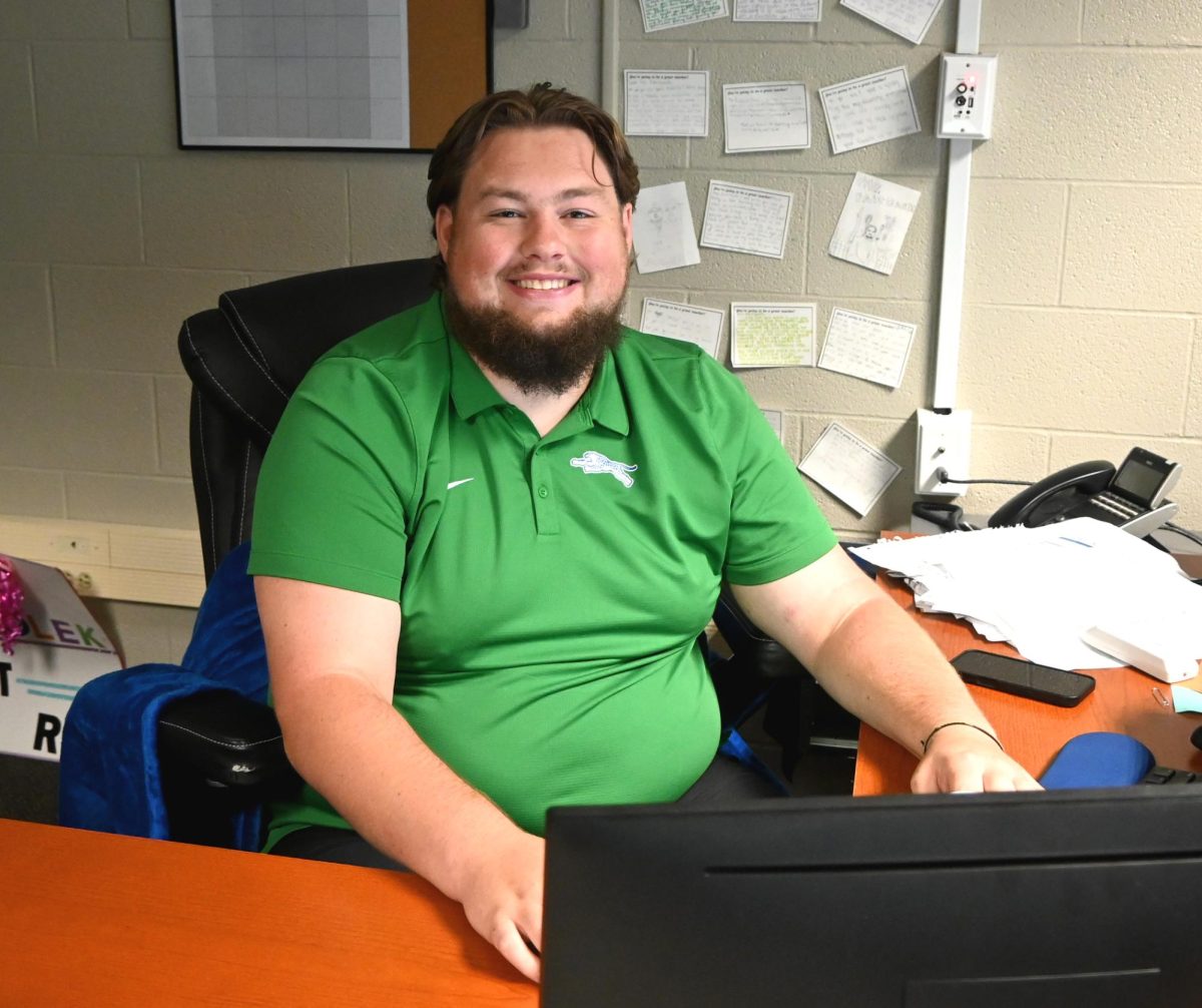 Gavin Fairbank works at his desk. He enjoys being back in the classroom, but this time, at a teacher's desk.