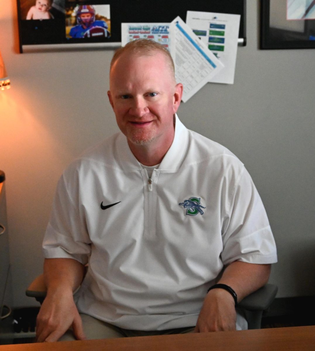 Dustin Spencer sits at his desk. He returns to South after working at Blue Springs High School. Photo by Maddox Hayden.