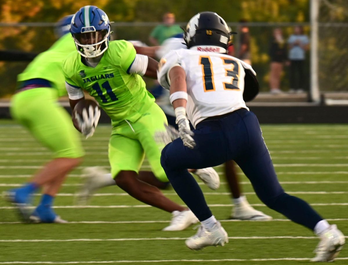 Jags senior wide receiver Gary Hill, #11, runs past against Liberty north defender. The Jags beat Liberty North 49-28 on August 29th. Photo by McKenzie Whayne