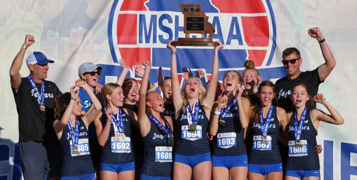 Girls cross-country team holding up state trophy. The last time they won state was in 2019. (Photo courtesy of Ryan Unruh) 
