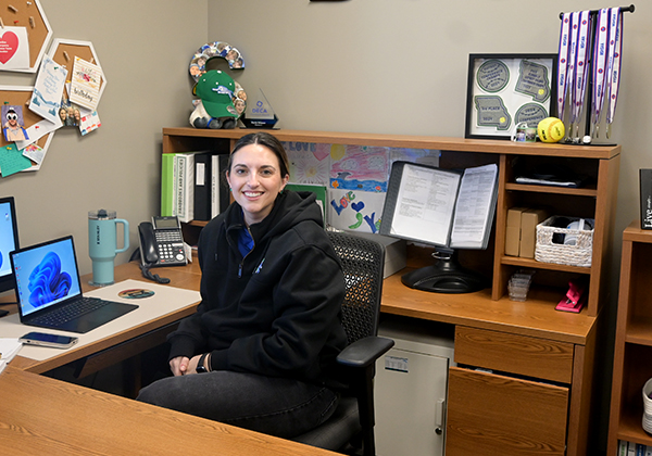 Darin Wisner sitting at her desk. Outside of school, she enjoy spending time with her kids. 