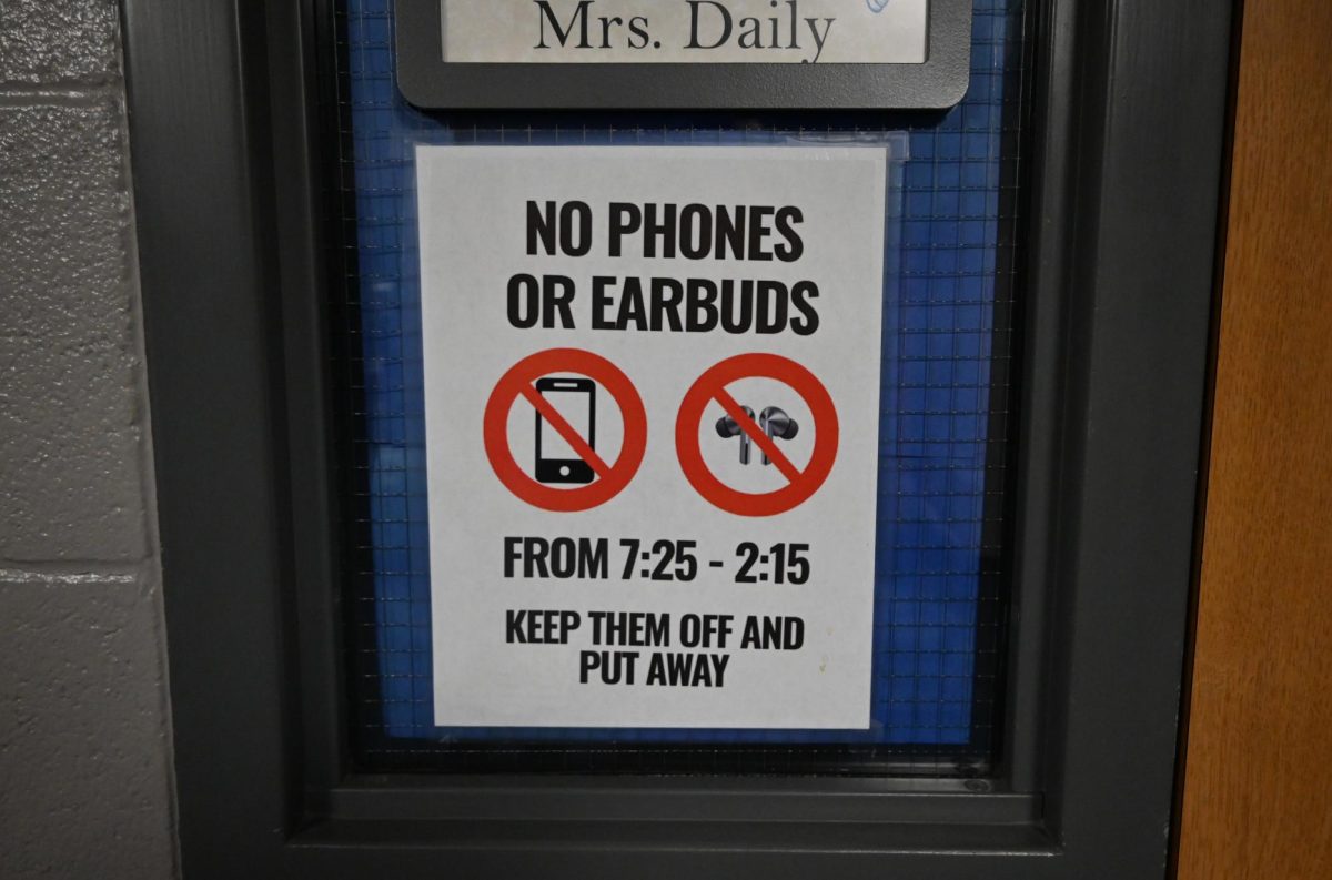 No cell phones poster outside a teachers classroom. The ban went into effect July 1, 2025.