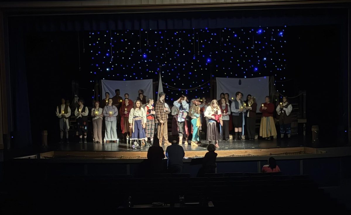 The cast of The Old Man and The Old Moon perform a song on stage. This show includes singing and dancing even though it's not a musical. 