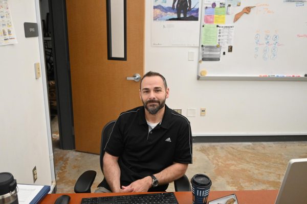 Jermey Baker sits at his desk. He has been named the 2026 Teacher of the Year. 